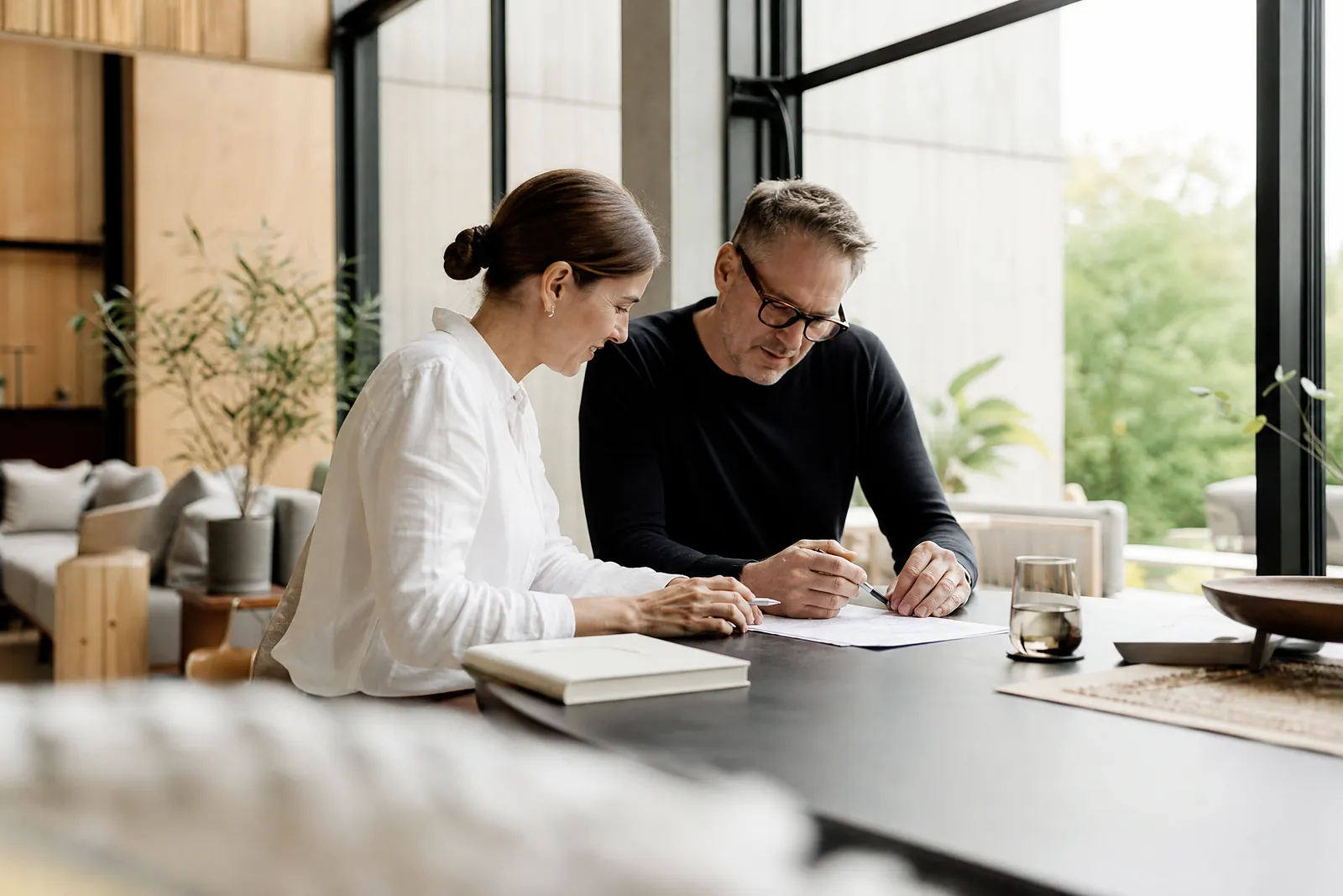 An advisor and a business owner working through a shared document in daylight