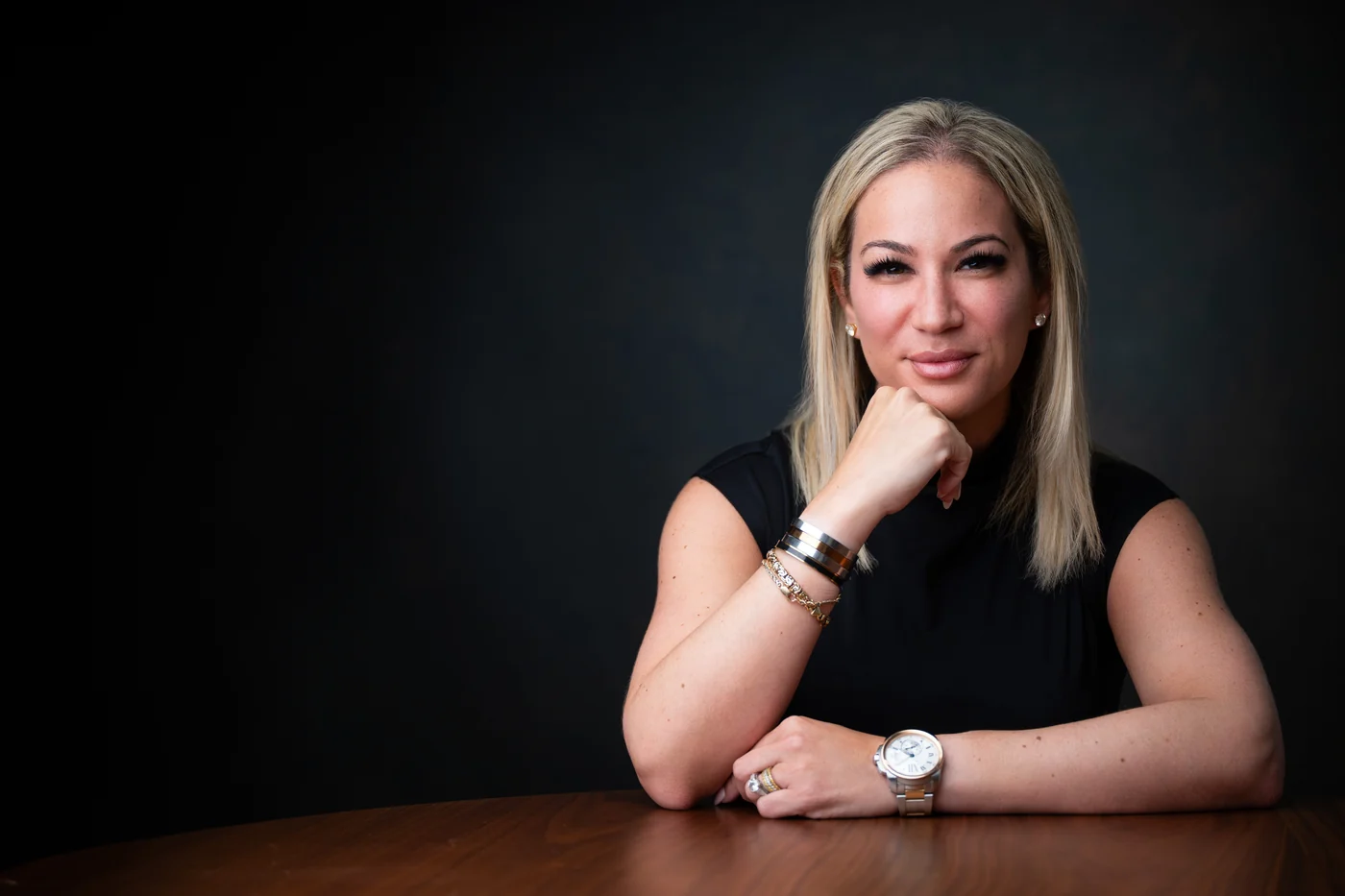 Jessica Cohen reviewing financial detail at a daylit desk.